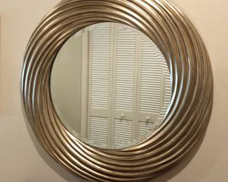 Impressive beveled wall mirror with gold-tone swirl-molded frame