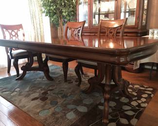 Beautiful double pedestal dining table with book-matched veneers, inlaid stringing, and two leaves