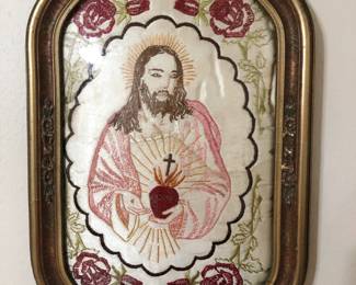 Several pieces of religious decorative arts including this framed embroidered textile, circa 1930