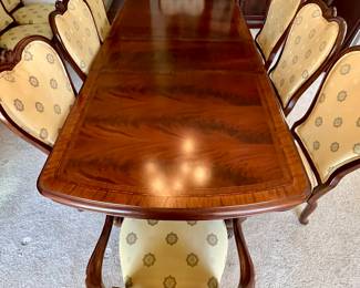 10 chairs plus another leaf and custom made padded table cover