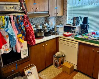 Vintage Aprons, Small Cast Iron Frying Pan, Microwave, Crock Pot, Vintage Coffee Pots, Lots of Pots and Pans, Miscellaneous Cooking Utensils and so much more