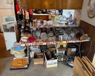 White Storage Cabinet, White Bread Keeper, Lots of Glassware, Coffee Pots, Silverplate Items, TV Trays and so much more