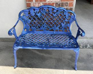 Blue cast iron garden bench with ornate design.