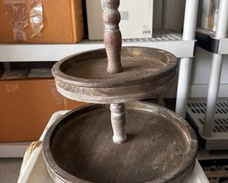Two-tier wooden display stand with mirror.
