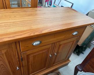 Oak sideboard cabinet with two drawers and doors.