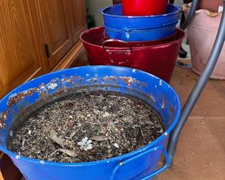 Assorted blue and red plastic buckets.