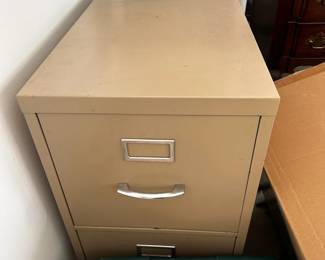 Beige metal two-drawer filing cabinet.