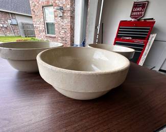 Stone mixing bowls - Set of two cream-colored concrete or stone bowls on wooden surface