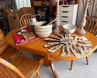 Round oak dining table with tableware - Wooden table with white ceramic bowls and silverware