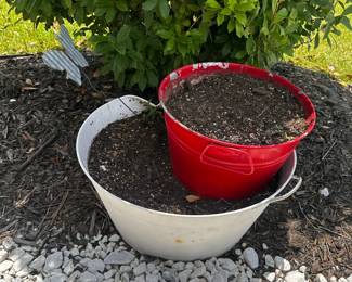 Red plastic planter and white plastic bucket.