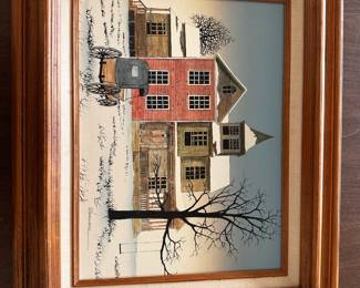 Framed winter house scene painting in wooden frame.