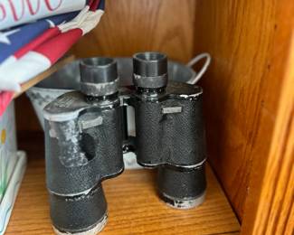Vintage binoculars - Black metal field binoculars on wooden shelf