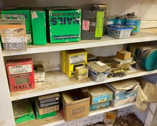 Numerous boxes and cans filled with nails