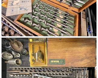 A wide assortment, including auger bits, masonry bits, and general-purpose twist drill bits, some in their original packaging from brands like Irwin and DeWalt.