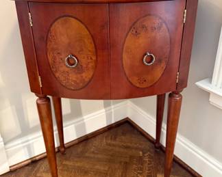 $250 - demilune table with burl wood on door in great condition; (23x16x33)
