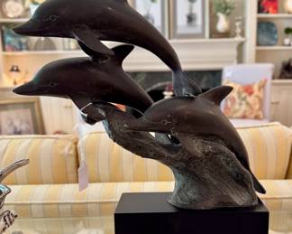 $200 - metal sculpture with 3 diving dolphins on base; 17"h