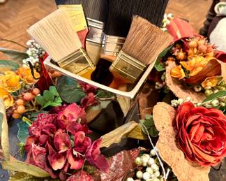 ($48; floral wreath) ($28; shiny silver planter)