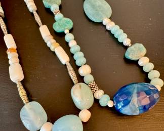 ($58; beaded necklace with natural stones and silver beads.) ($78; natural stone necklace with blue faceted main stone.)