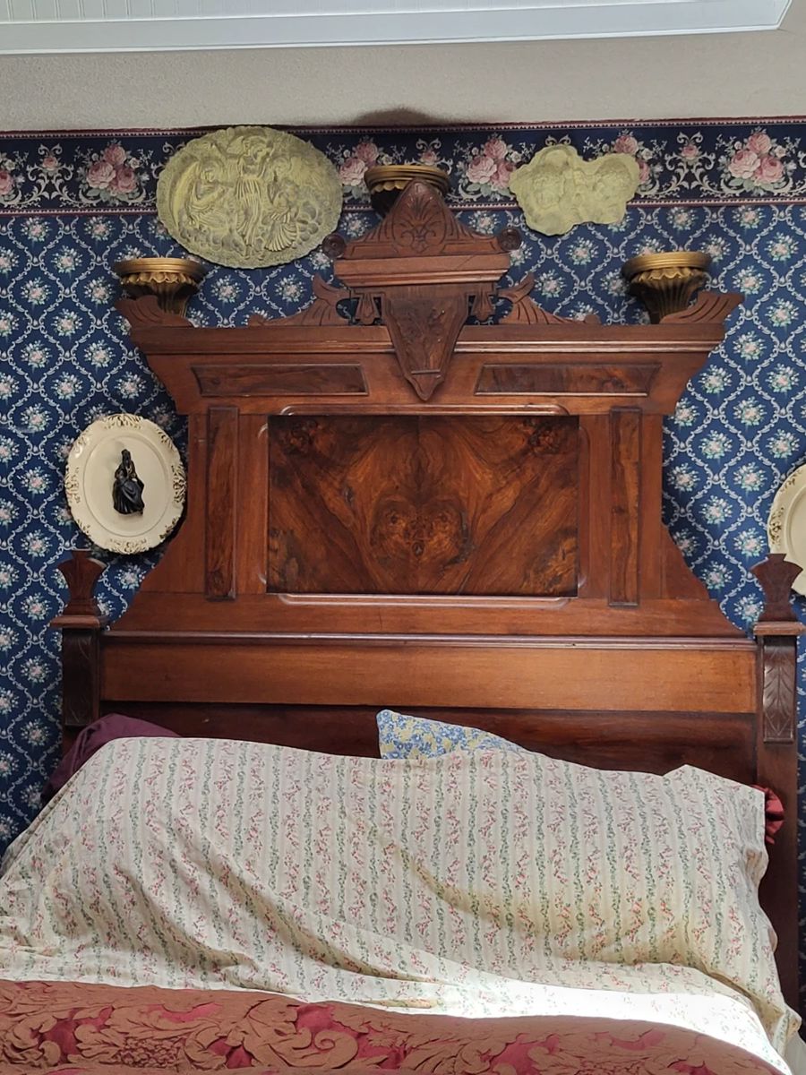 Beautiful antique full size bed with unusual naturally occuring face in wooden headboard . No mattress and boxspring.
