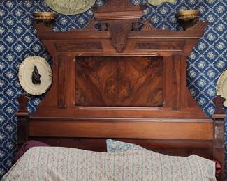 Beautiful antique full size bed with unusual naturally occuring face in wooden headboard . No mattress and boxspring.