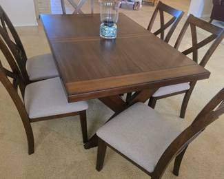 Diningroom table with 6 upholstered chairs with leaf attached