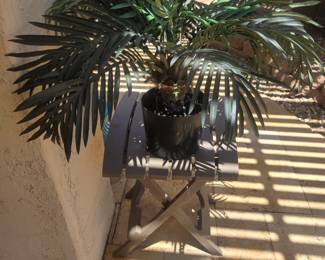 Small stand with palm tree in planter