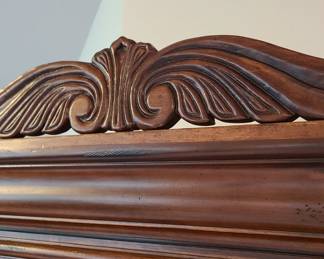 Close up view of the top, removable piece of the curio cabinet.
