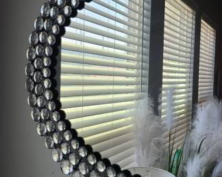 Lots of wall decor including two large mirrors and two small matching sconces.