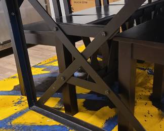 View of the metal legs on the dinning table, and also the very unique dyed cowhide rug.