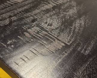 Close up of the dinner table black wood top.