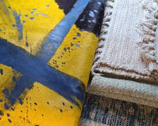 Lots of rugs including the larger dyed cowhide rug.