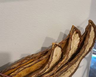 Three wooden, hand-carved canoes that have been tobacco smoked. Very unique.