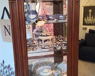 Curio cabinet which is one of the best deals of the entire sale. Glass on all sides including three shelves, and it has lights inside. The top decorative crown molding is removable if you want to change the style.
