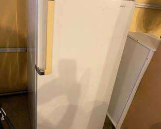Small upright freezer.