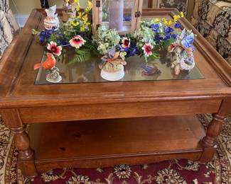 Wood framed glass top coffee table. Top lifts for storage of decor