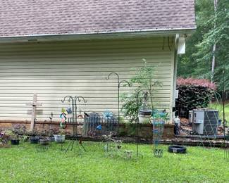 Many many yard decor items and flower pots. 