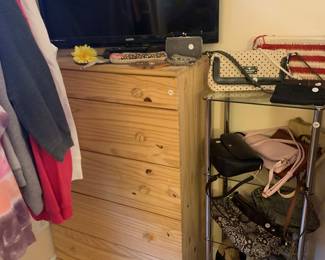 Wood dresser, purses and a tv