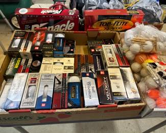Gold balls still in boxes - located in detached garage