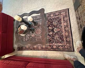 Wool rug and square glass top coffee table
