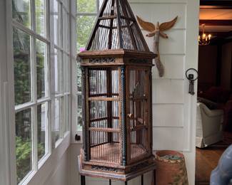 Large antique bird cage on stand