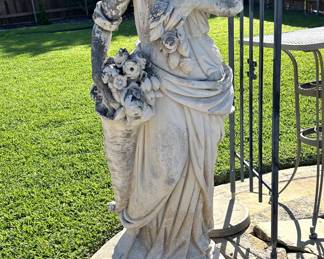 Multiple garden statues, trellises, iron art, and stone pottery