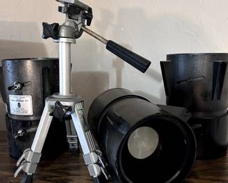 Tripods of multiple sizes and large-format camera equipment.