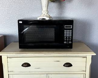 Night stand ($85.00)  microwave ($28.00) and floral arrangement 
( $12.00) 