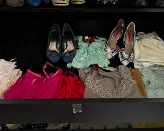 Shelves of camisoles, shirts, and sweaters