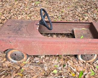 Old pedal car yard art