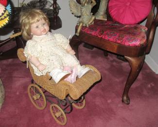Steffans baby doll in old wicker carriage