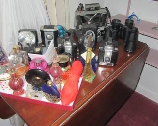 Steffans drop leaf table with perfumes cameras binoculars