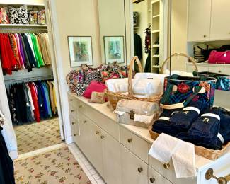 THREE COUNTERS FULL OF HANDBAGS.