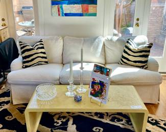 Asian waterfall table with carved figures. White sofa in fabulous condition, feather down. Retail $4864.