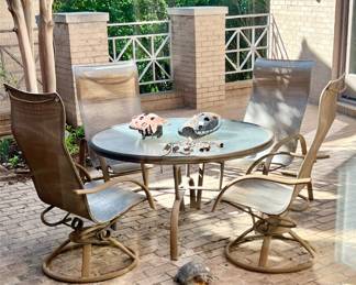 GLASS TOP PATIO TABLE WITH 2 SWIVEL CHAIRS AND 2 ARM CHAIRS.